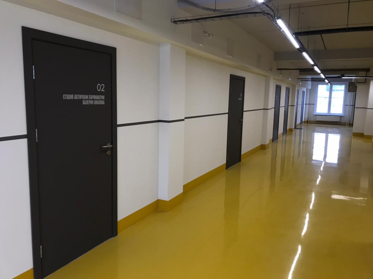 Распашные темные офисные двери в коридоре бизнес-центра